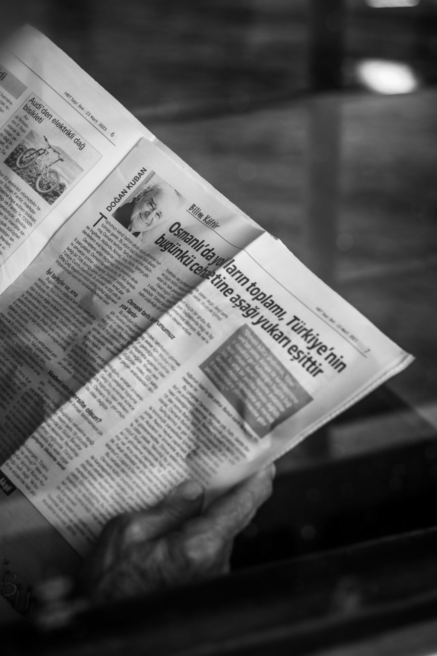 Journalist reviewing prints and newspaper layout